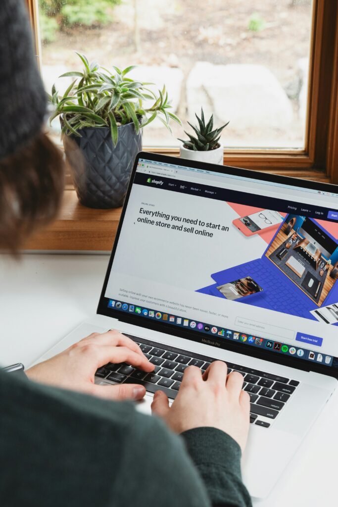 Person using a laptop to manage a Shopify online store, showcasing eCommerce website management and online business operations.